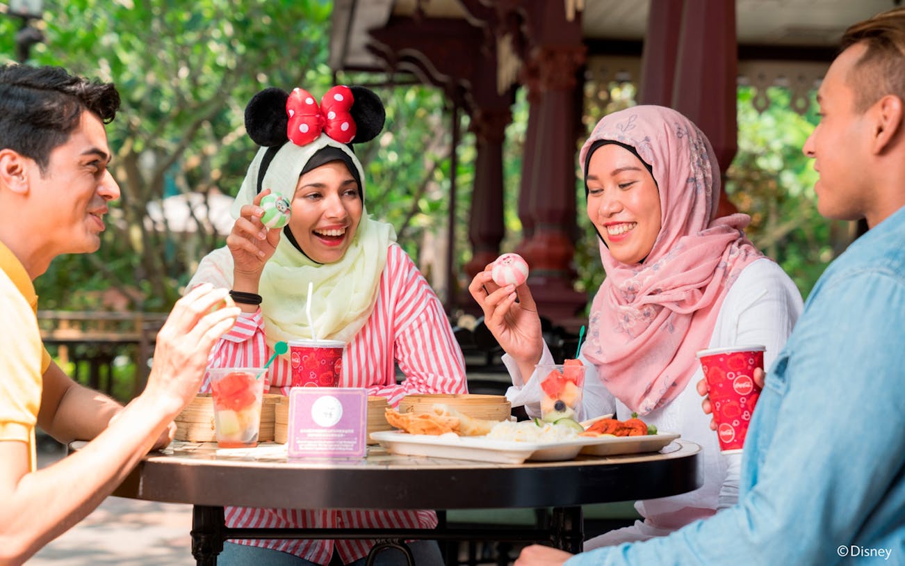 Visitors enjoying a meal at Disneyland Hong Kong food court.