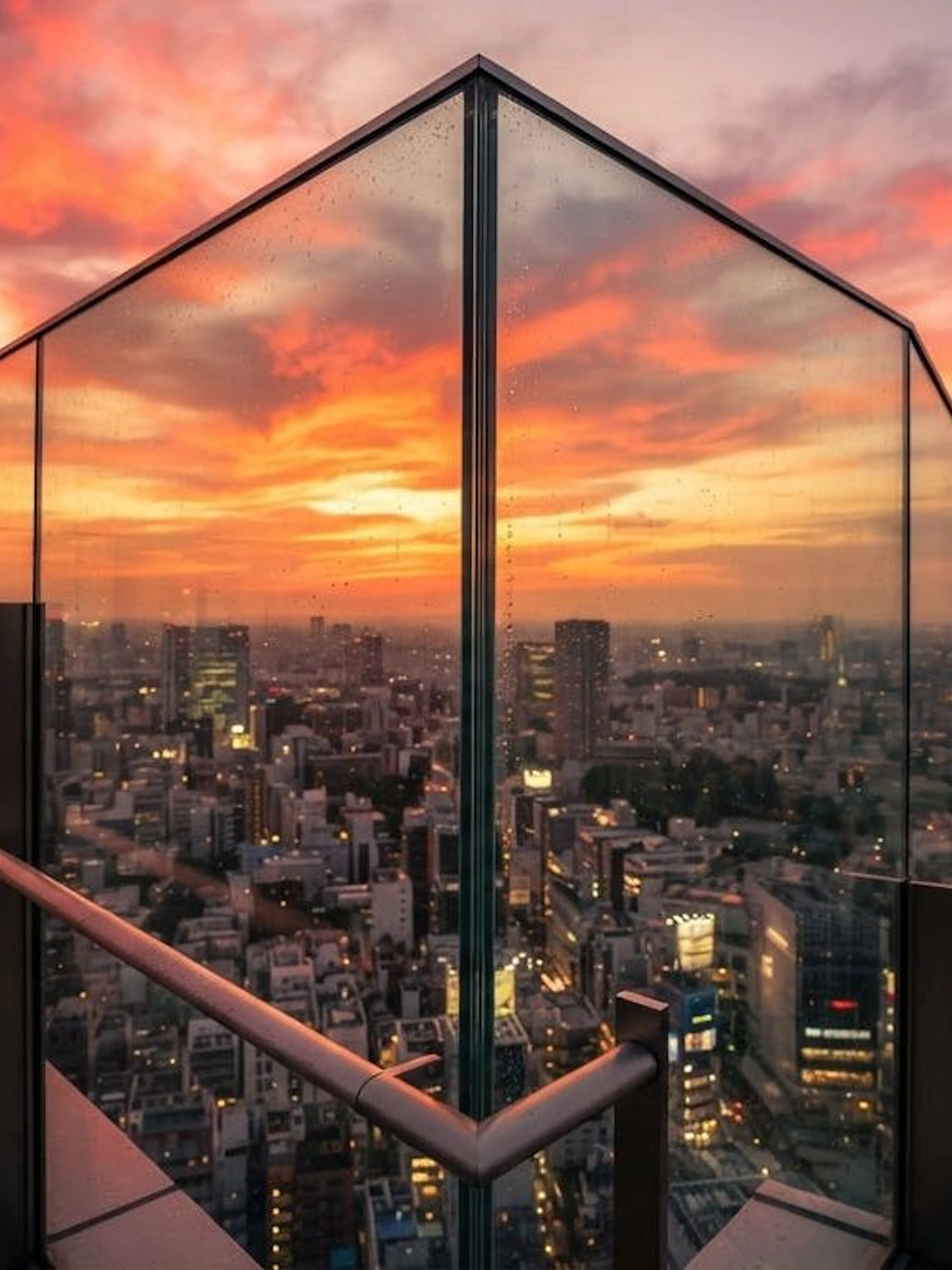 Tokyo skyline at sunset from Shibuya Sky observation deck, overlooking Shibuya Scramble Crossing.