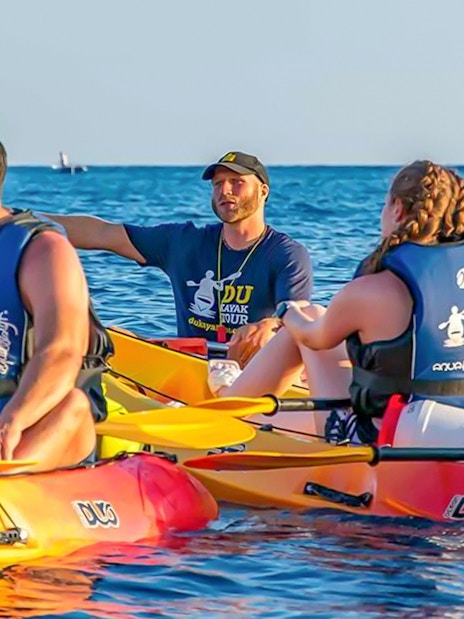 Kayakers with a guide on a sunset tour in Dubrovnik.