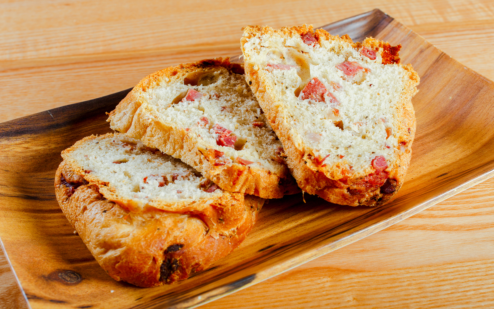 Traditional Neapolitan tortano with cured meats, sliced and ready to eat.