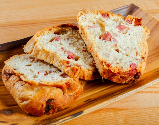Traditional Neapolitan tortano with cured meats, sliced and ready to eat.