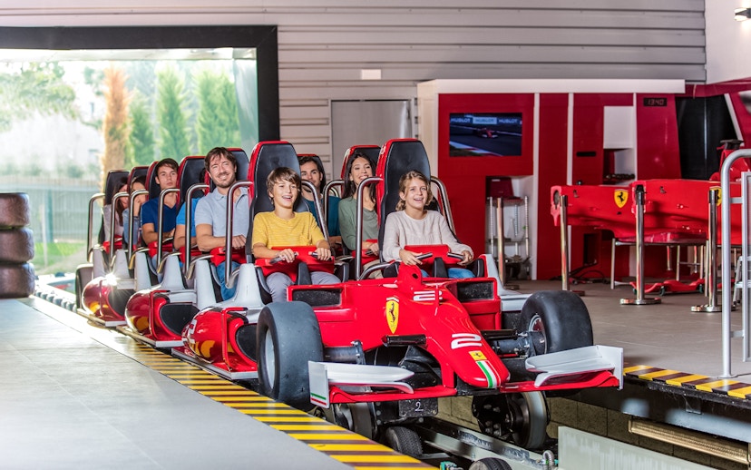 Tourists on a Ferrari-themed ride at Ferrari Land.