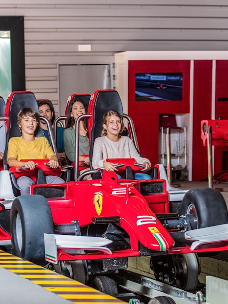 Tourists on a Ferrari-themed ride at Ferrari Land.