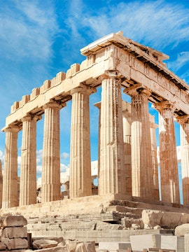 Parthenon columns under blue sky in Athens, Greece.