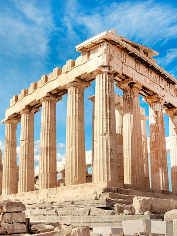 Parthenon columns under blue sky in Athens, Greece.