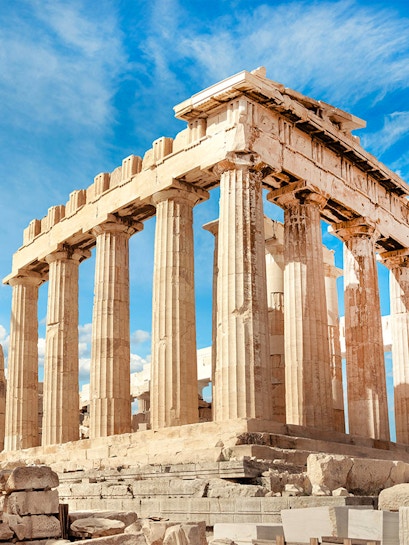 Parthenon columns under blue sky in Athens, Greece.
