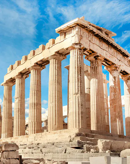 Parthenon columns under blue sky in Athens, Greece.