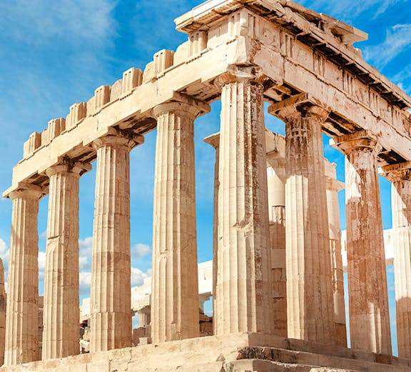 Parthenon columns under blue sky in Athens, Greece.