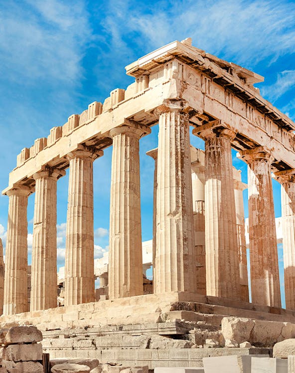 Parthenon columns under blue sky in Athens, Greece.