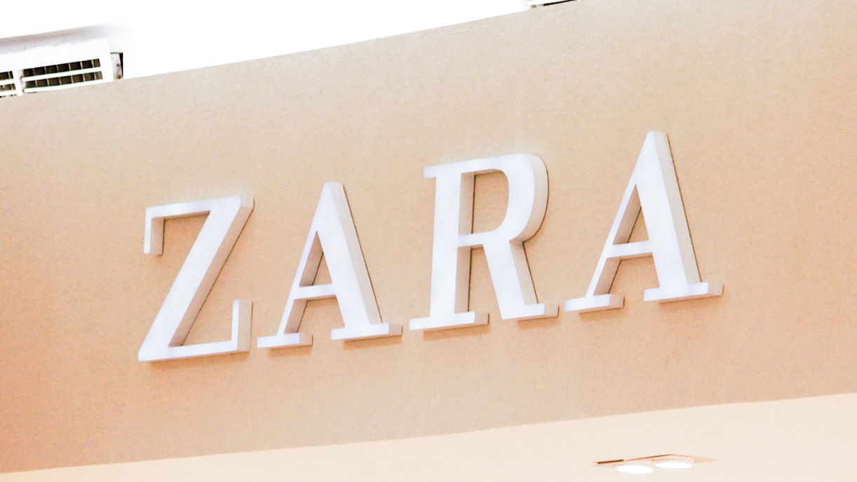 Zara store entrance with logo in a shopping district.