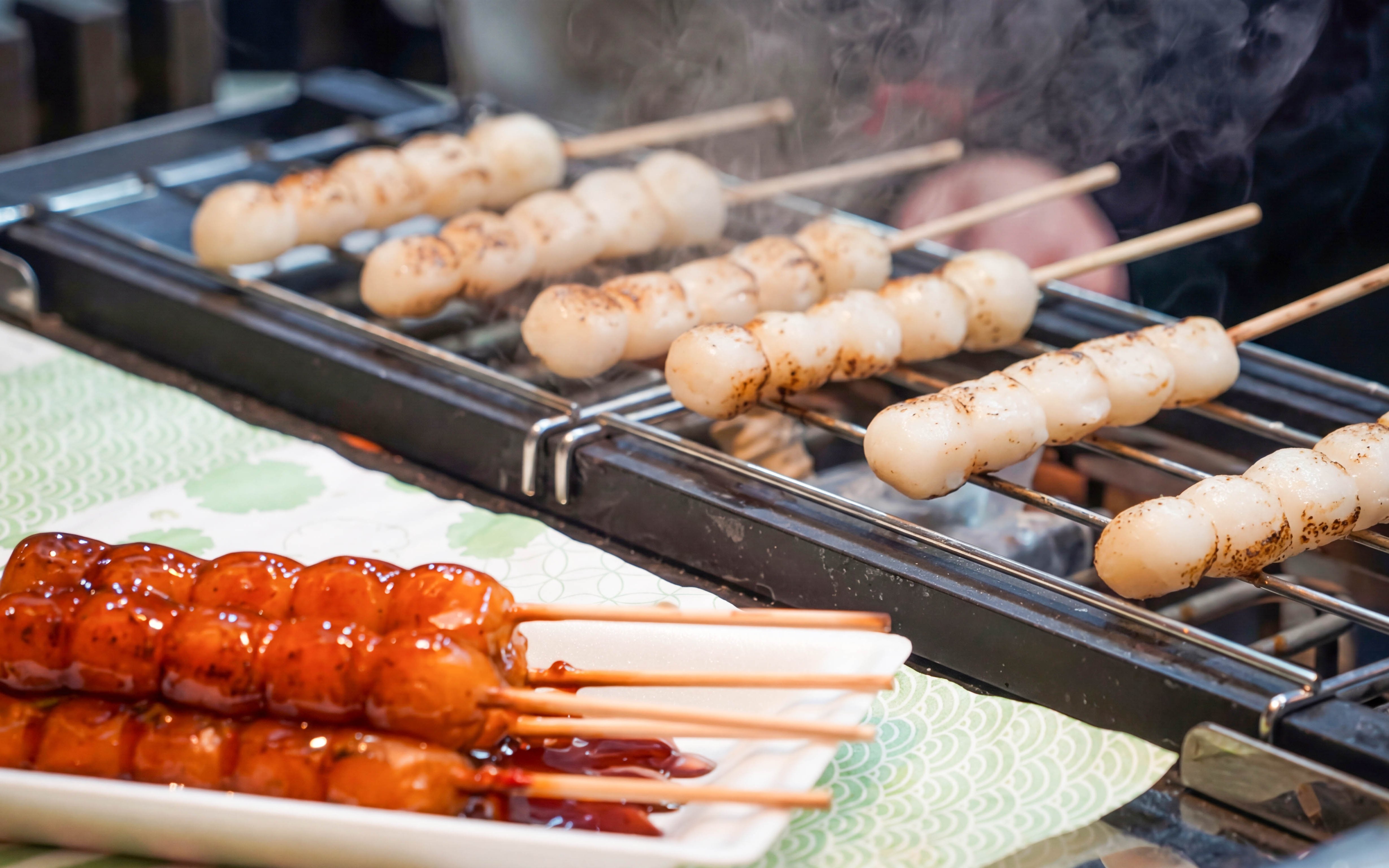 Grilled dango skewers at Nishiki Market brunch in Kyoto.