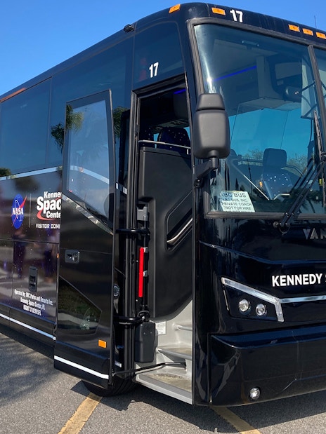 Kennedy Space Center tour bus parked in Florida lot.