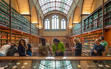 Visitors exploring exhibits in the Rijksmuseum library, Amsterdam.