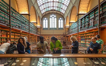 Visitors exploring exhibits in the Rijksmuseum library, Amsterdam.