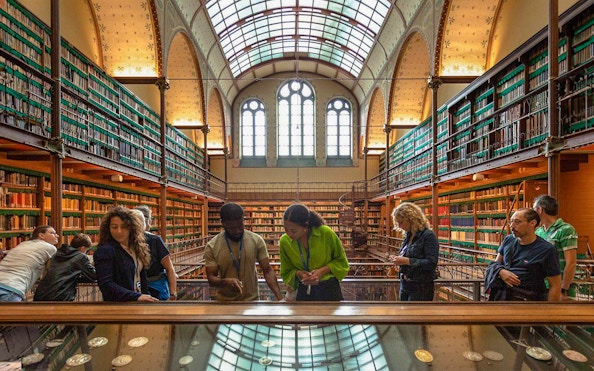 Visitors exploring exhibits in the Rijksmuseum library, Amsterdam.