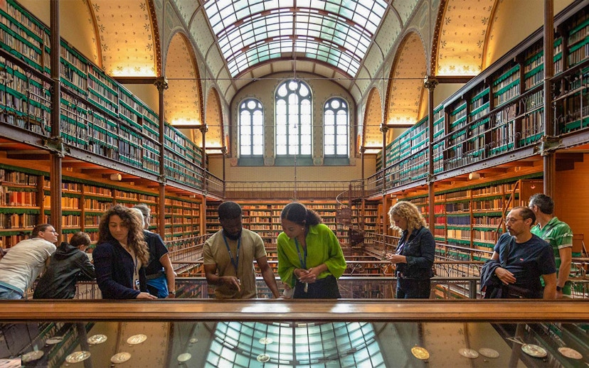 Visitors exploring exhibits in the Rijksmuseum library, Amsterdam.