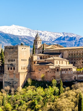 Alhambra Palace with Sierra Nevada mountains in Granada, Spain, seen on Malaga to Granada tour.