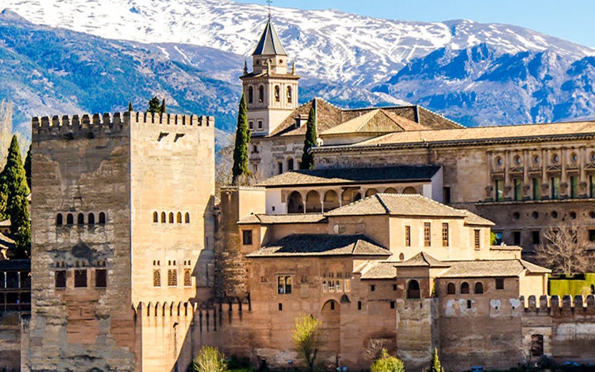 Alhambra Palace with Sierra Nevada mountains in Granada, Spain, seen on Malaga to Granada tour.