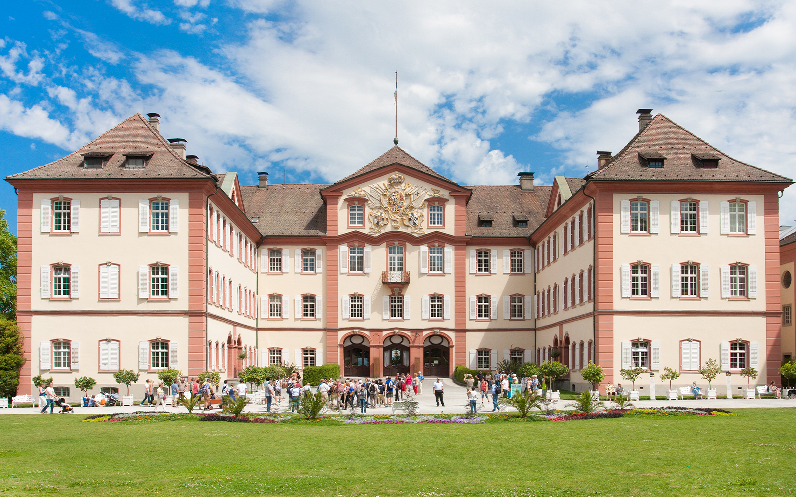 Castle on Mainau Flower Island with visitors in front, Germany.