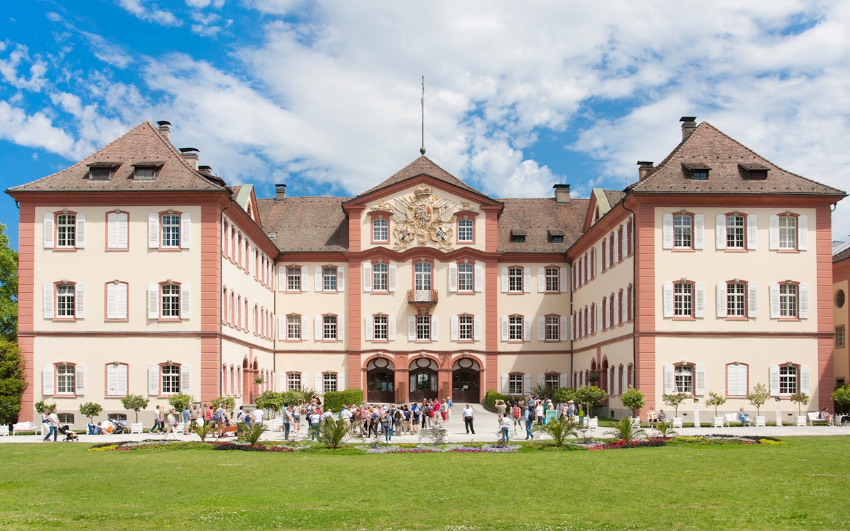 Castle on Mainau Flower Island with visitors in front, Germany.