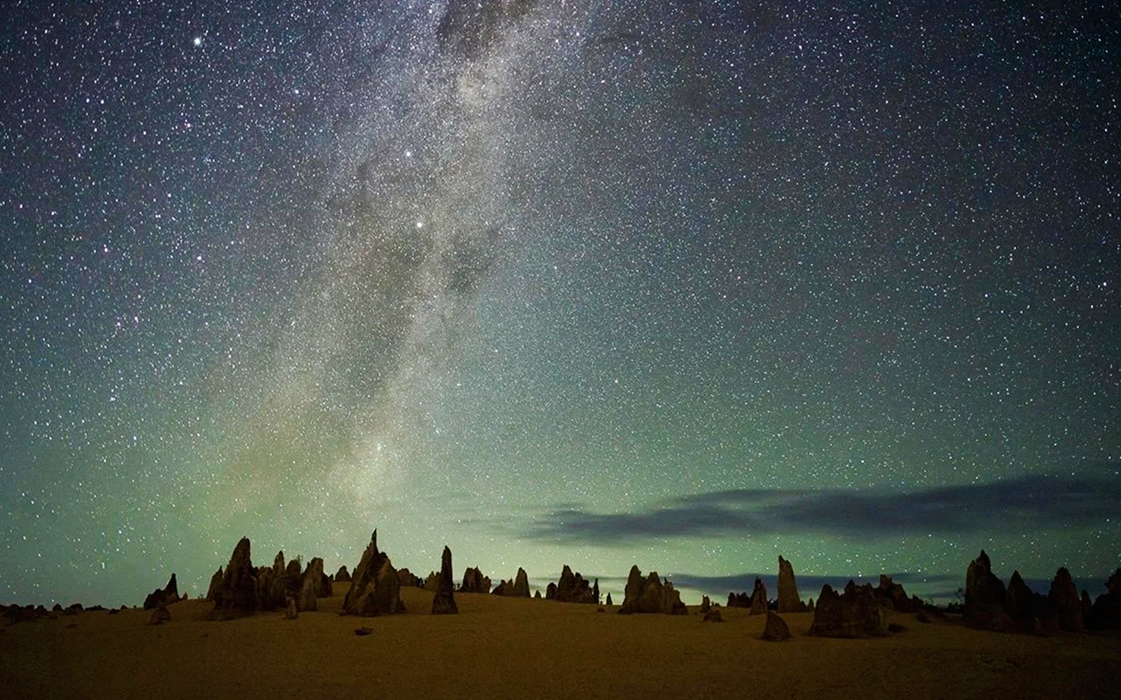 Pinnacles Desert under starry sky during sunset, ideal for stargazing and wildlife spotting tour.