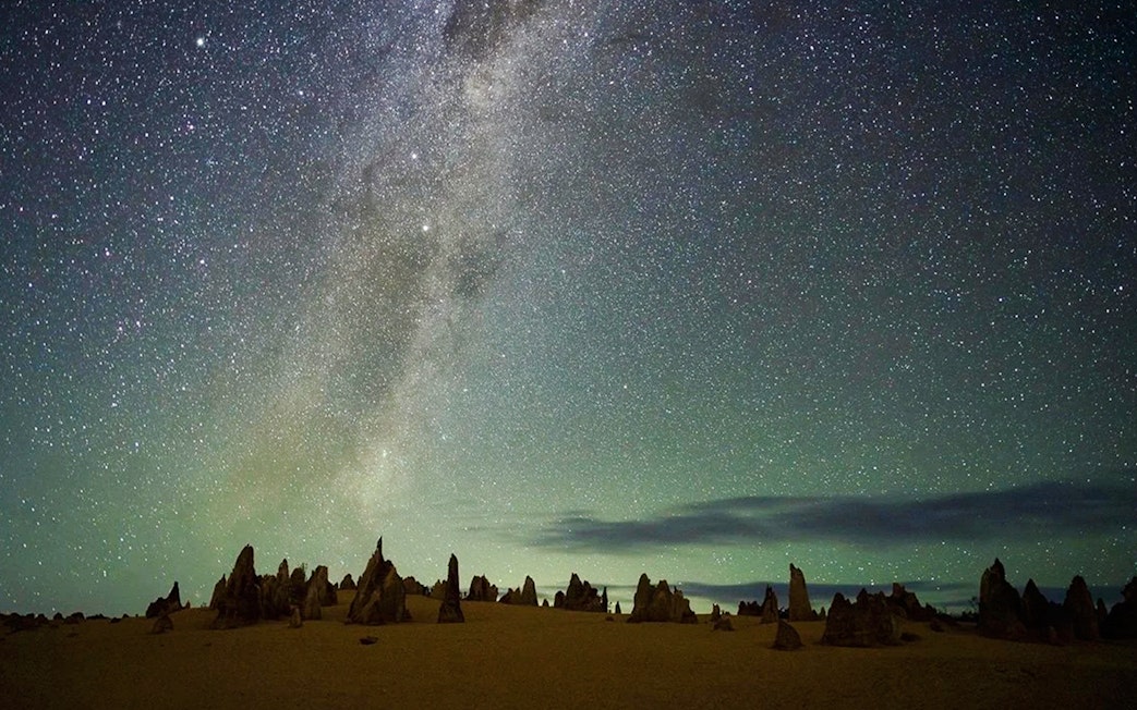 Pinnacles Desert under starry sky during sunset, ideal for stargazing and wildlife spotting tour.