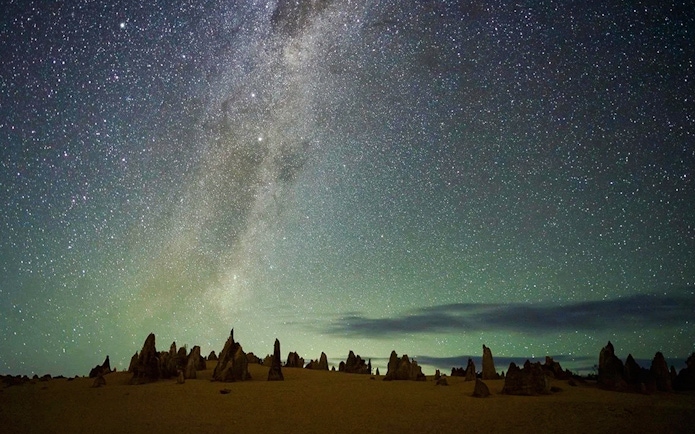 Pinnacles Desert under starry sky during sunset, ideal for stargazing and wildlife spotting tour.