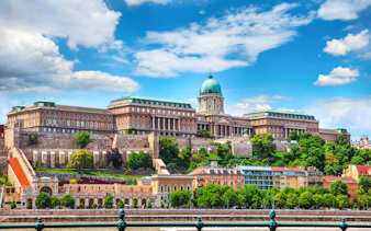 Buda Castle Royal Palace on a hill in Budapest, Hungary, with clear blue sky.