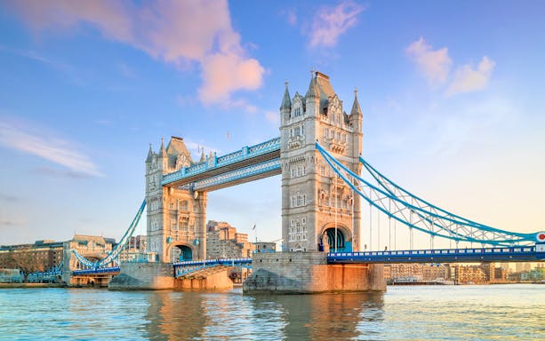 Tower Bridge over the Thames River in London at twilight.