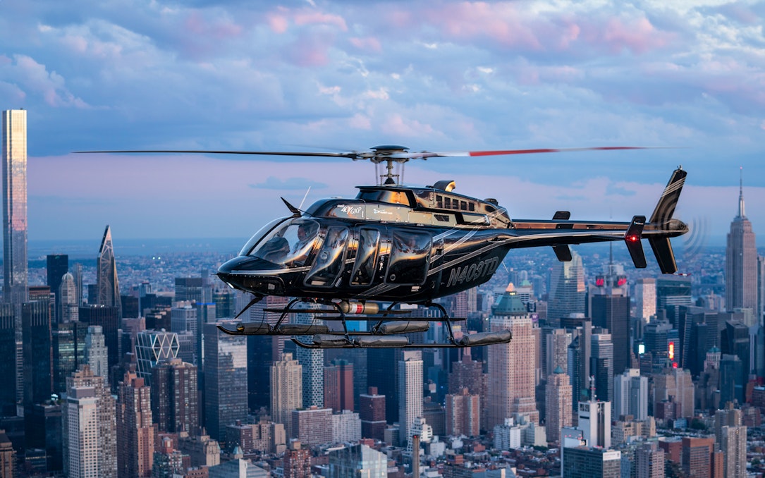 Helicopter flying over New York City skyline during City Lights NYC Helicopter Night Tour.