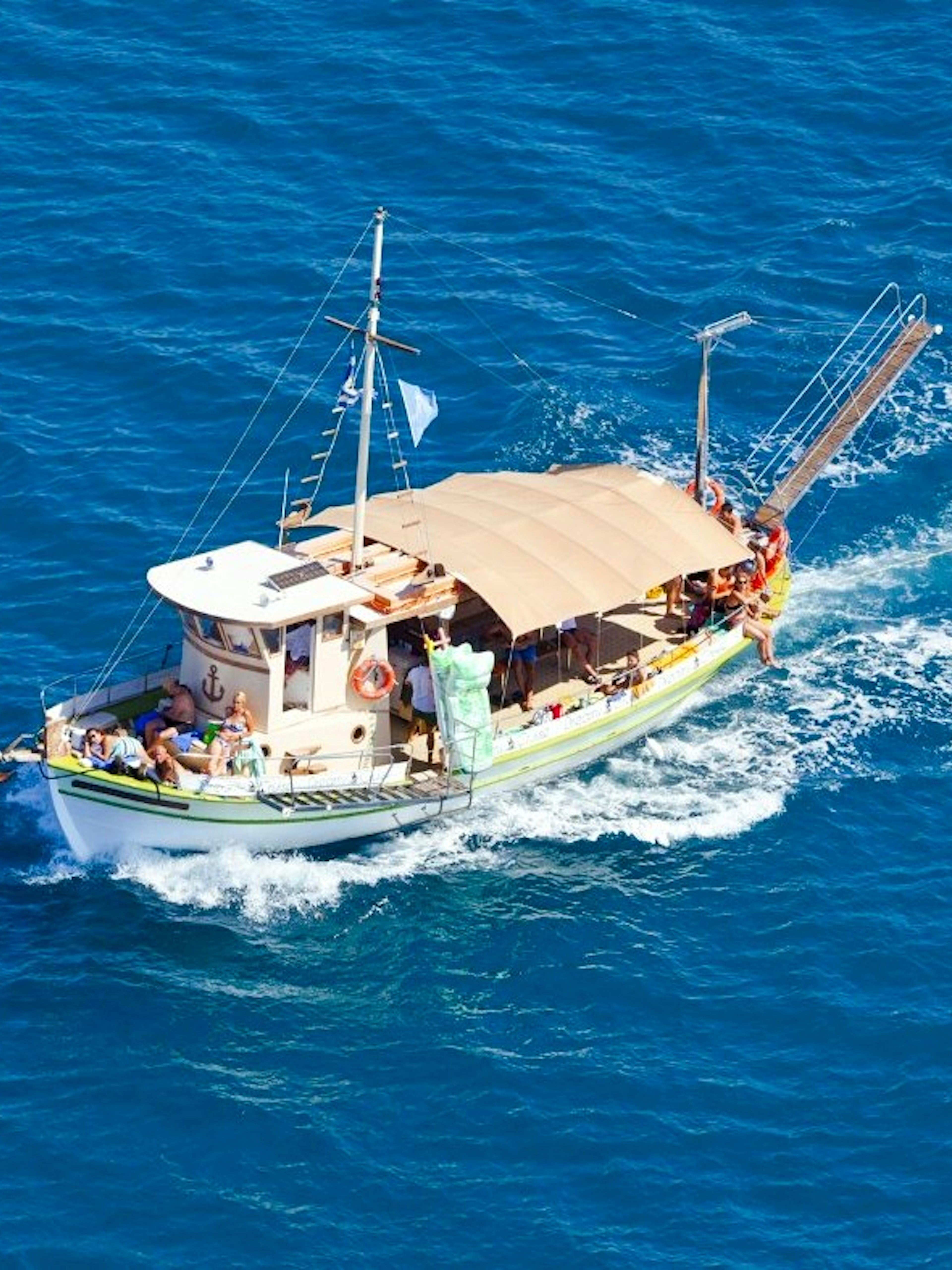 Daily cruise boat sailing in blue waters from Kefalonia.
