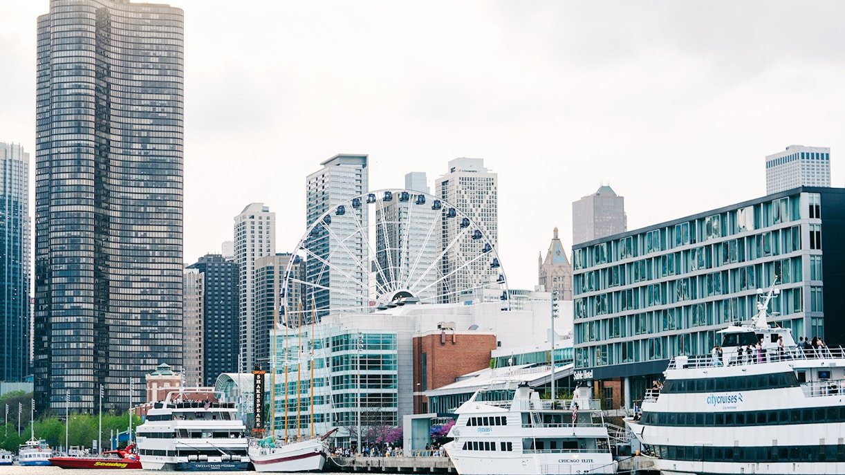 Navy Pier in Chicago with Centennial Wheel and boats docked nearby.