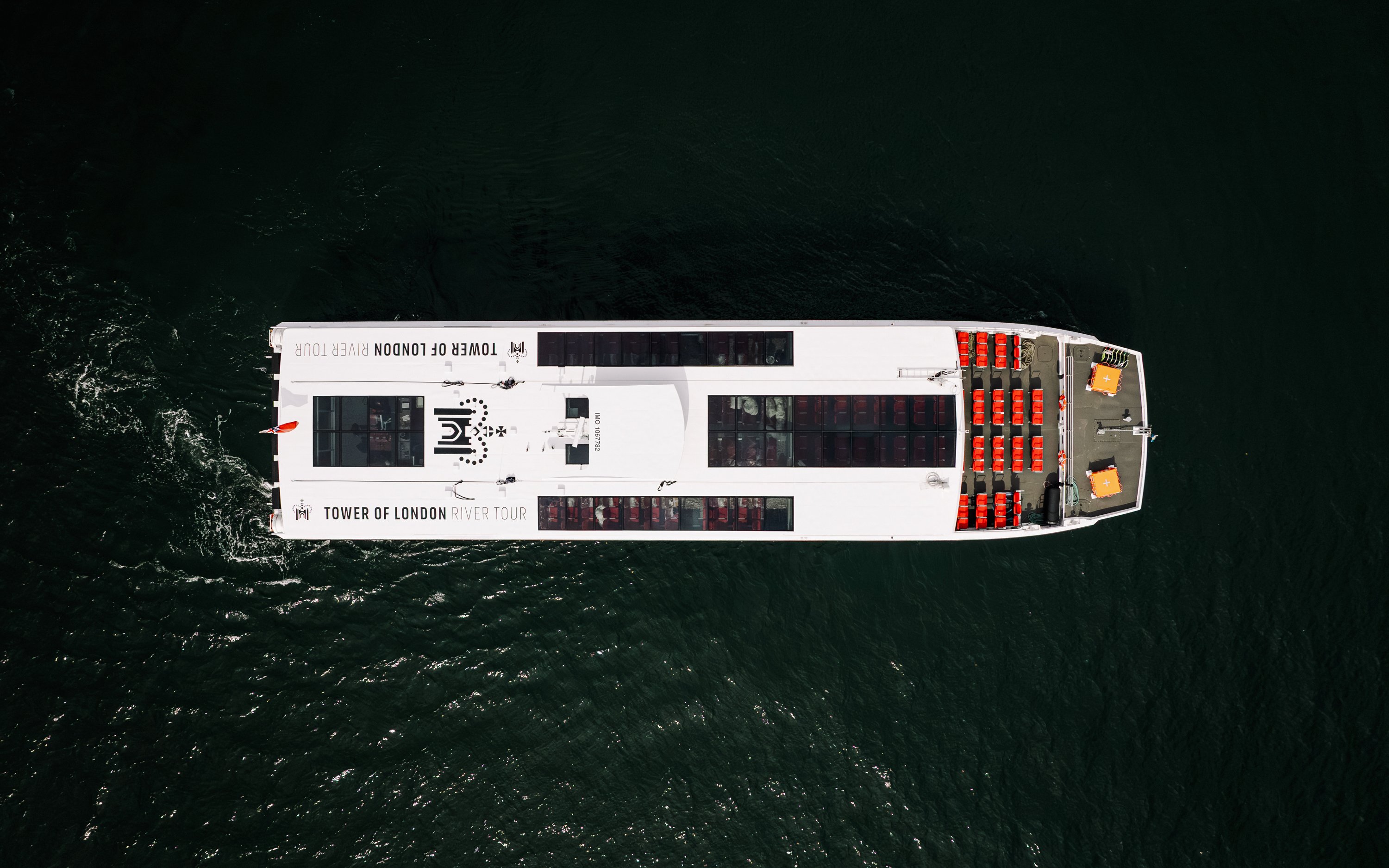 Aerial view of Tower of London river tour boat on the Thames.