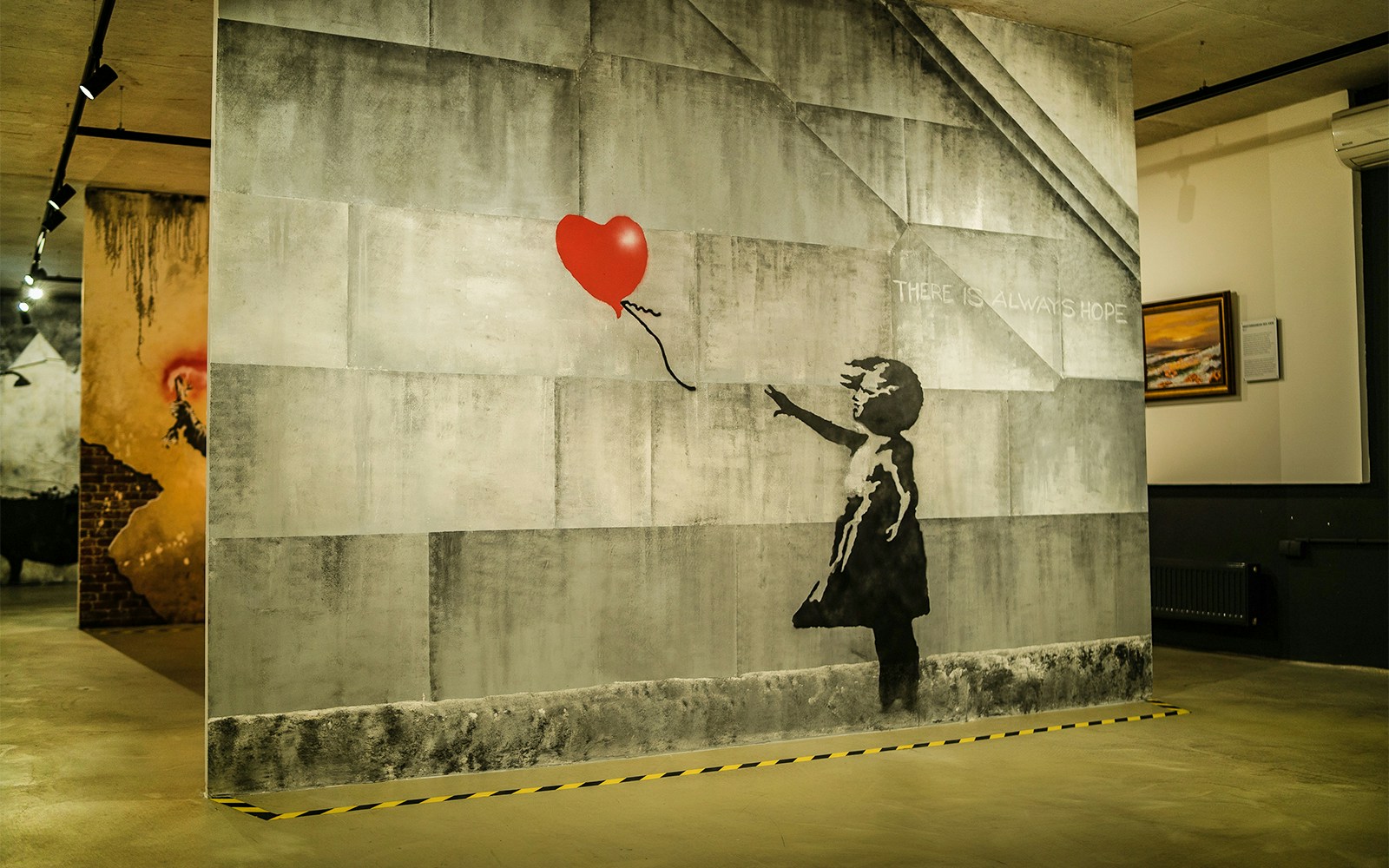 Banksy artwork of a girl with a balloon at the Banksy Museum in Krakow.