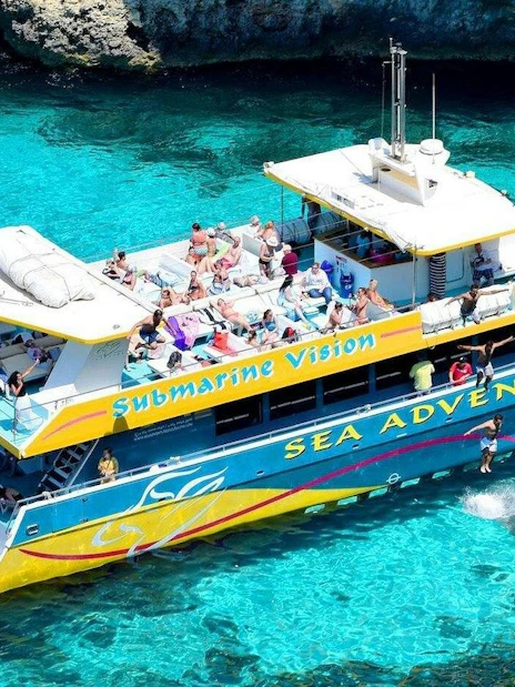Sea adventure boat with tourists at Blue Lagoon, clear turquoise water.