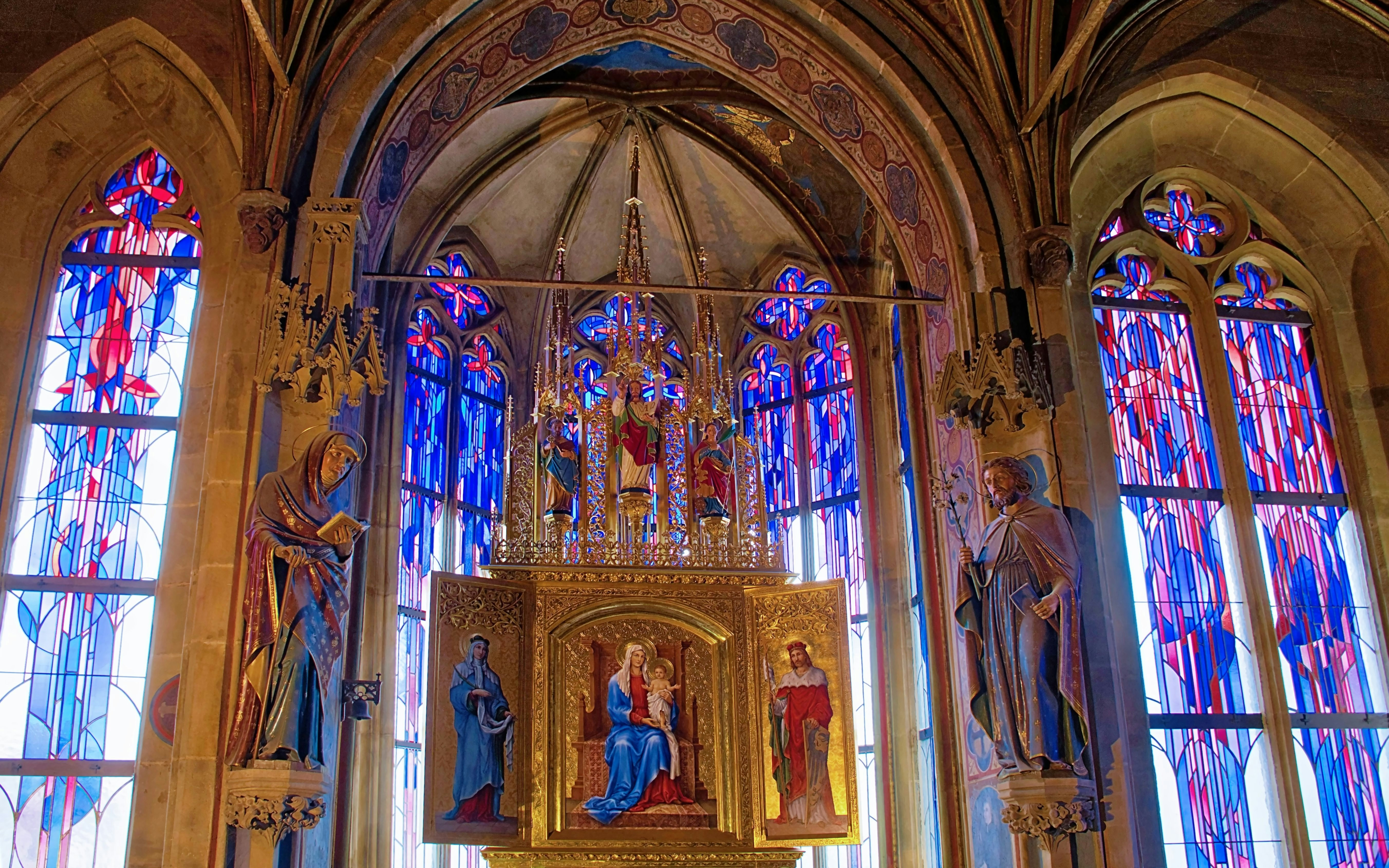 Interior of The Old Town Hall in Prague with stained glass windows and religious artwork.