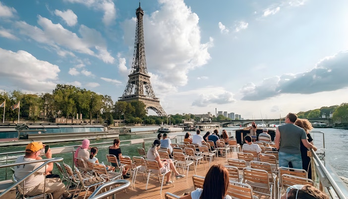 Seine River cruise with a few passengers viewing Eiffel Tower, Paris.