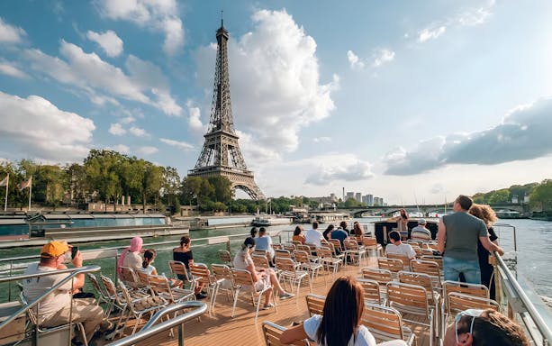 Cruise passengers viewing the Eiffel Tower from the Seine River in Paris.