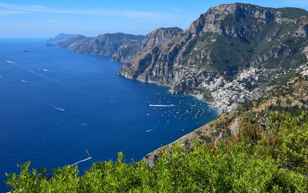 View of Amalfi Coast from Sentiero degli Dei trail, Italy, with cliffs and sea.
