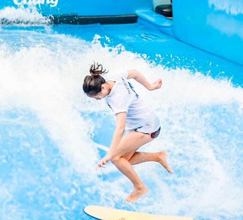 People surfing on artificial wave at Flow House Bangkok.