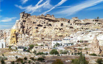 Cavusin village rock formations and ancient dwellings in Cappadocia, Turkey.