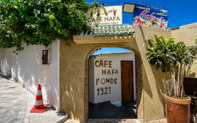 Cafe Hafa entrance with ivy-covered walls in Tangier, Morocco.