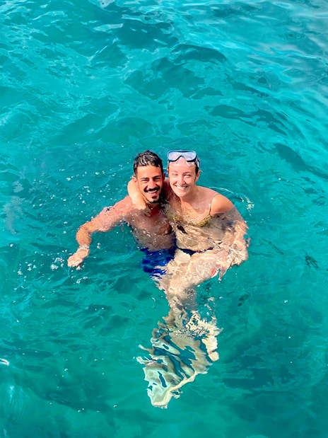 Couple swimming in clear blue waters near Capri on a tour from Sorrento.