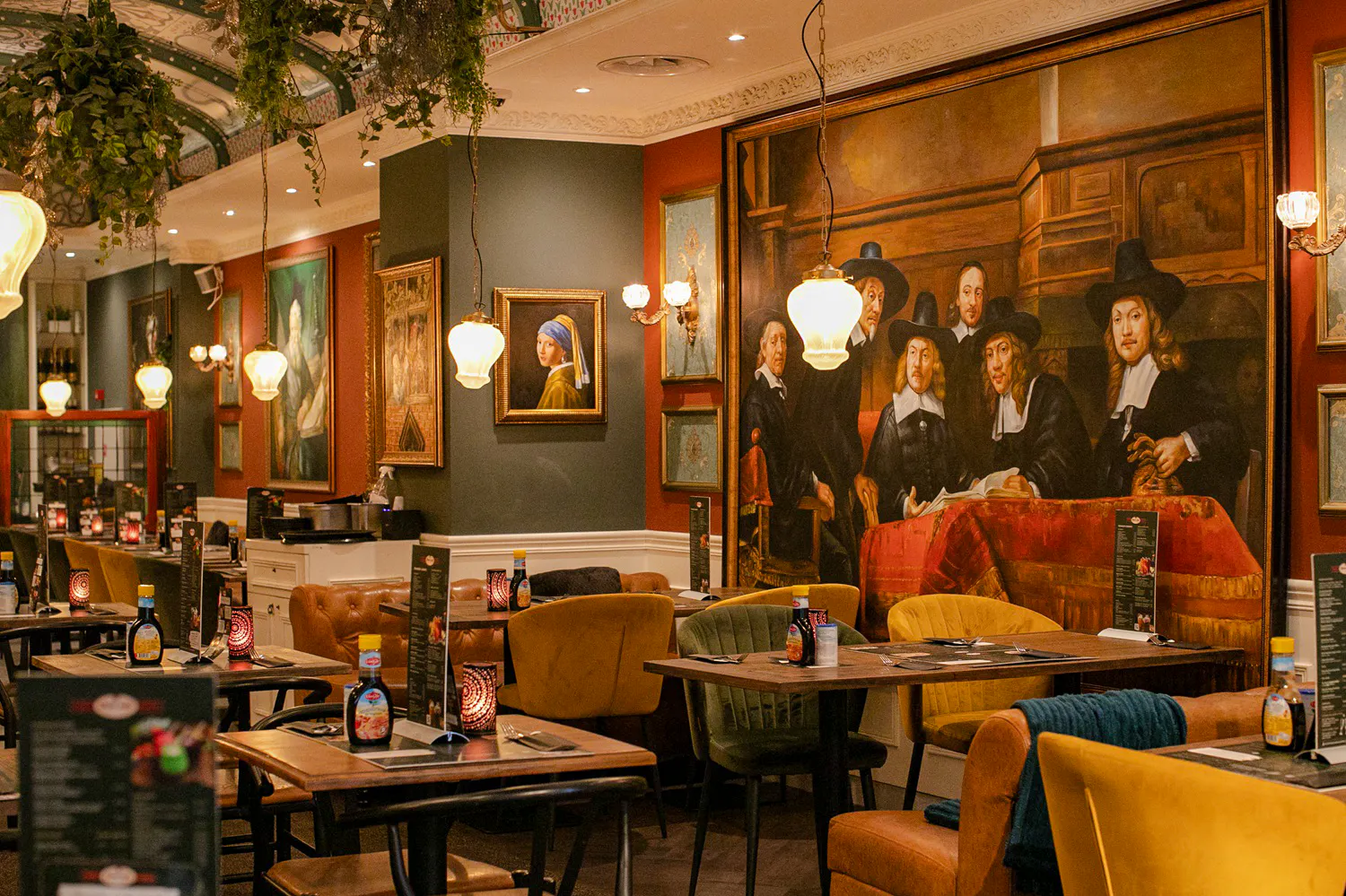 Dining area with Rembrandt-style paintings, Amsterdam brunch tour location.