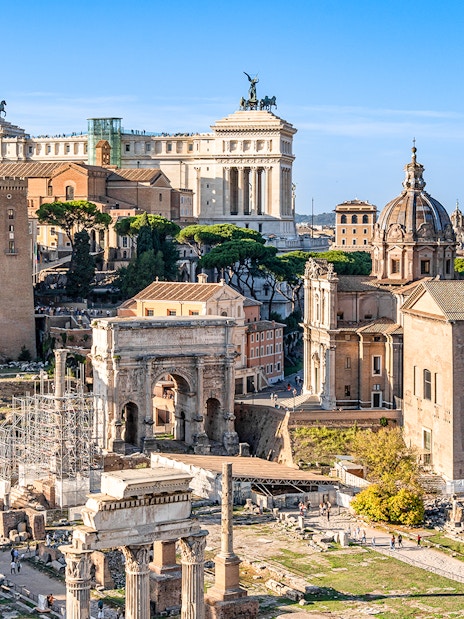 Roman Forum ruins with surrounding historic buildings, part of Colosseum, Palatine Hill & Roman Forum tour.