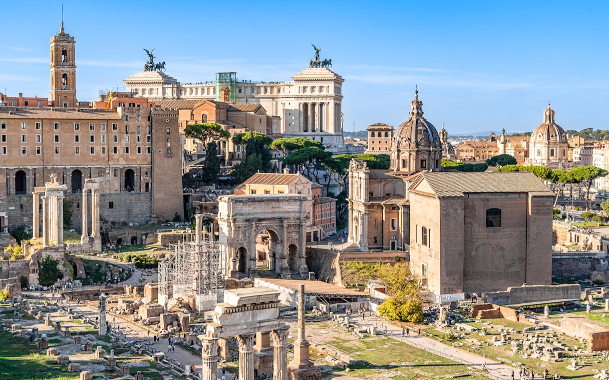 Roman Forum ruins with surrounding historic buildings, part of Colosseum, Palatine Hill & Roman Forum tour.