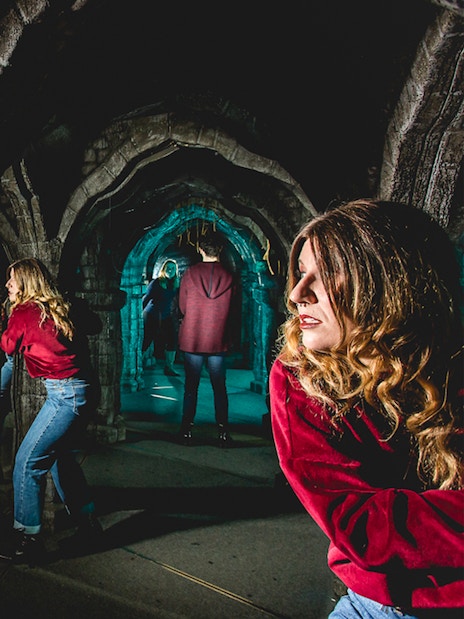 Visitors exploring mirror maze at Edinburgh Dungeon Tour.
