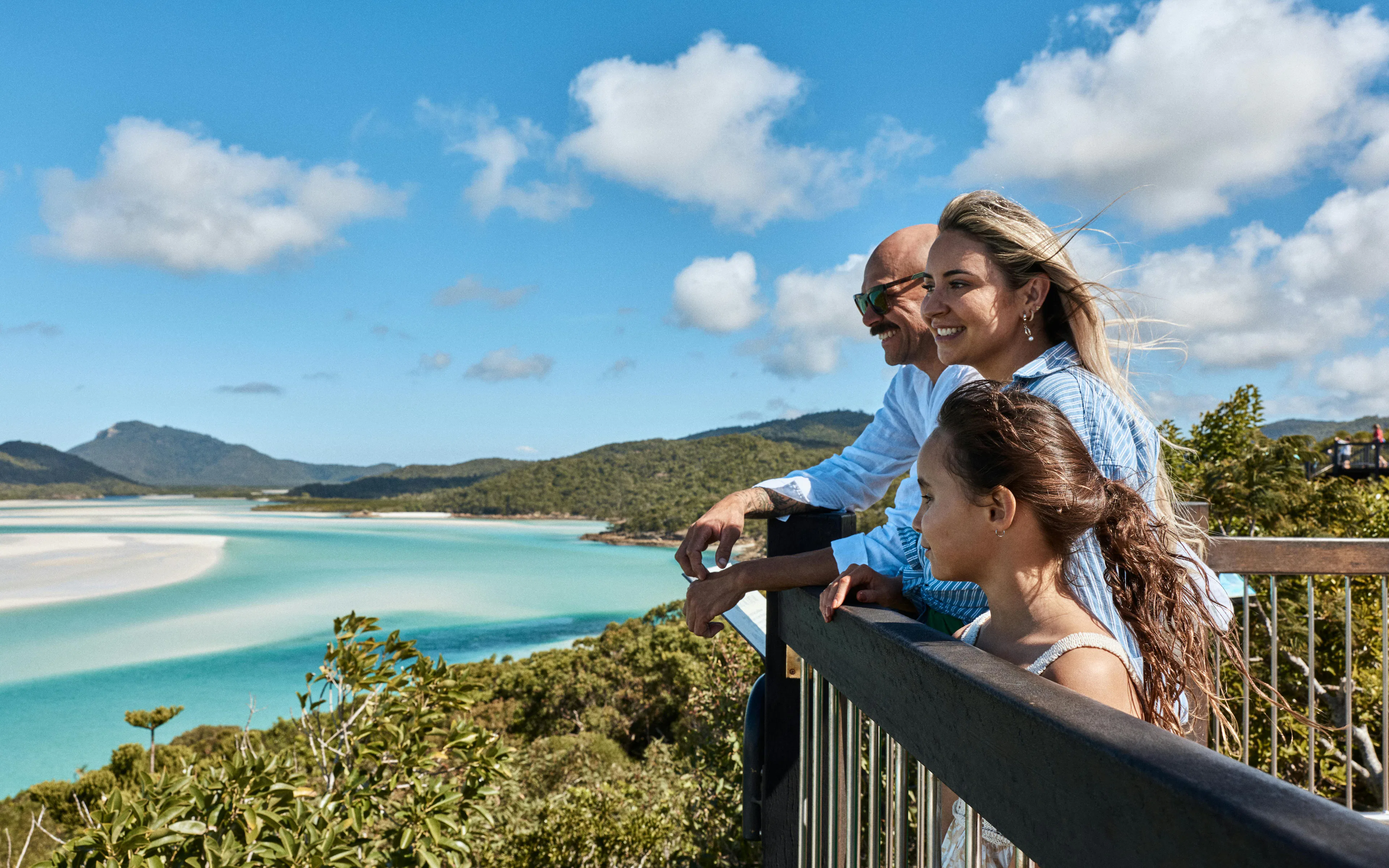 Visitors enjoying the view of Whitehaven Beach and Hill Inlet from a lookout, Whitsundays Island.