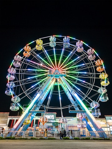 Old Town Ferris Wheel lit up at night in Orlando.