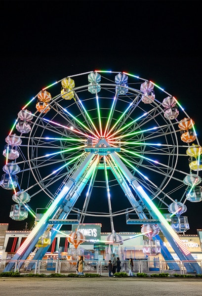 Old Town Ferris Wheel lit up at night in Orlando.